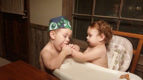 Noah (3) teaching David (1) how to properly share donuts.